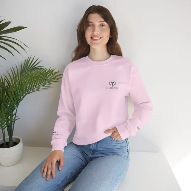 Person wearing a light pink Hartford crewneck sweatshirt